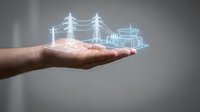 Hand holding glowing holographic power grid with transmission towers and electrical infrastructure for energy technology concepts.