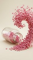 Pink pills spilling from glass jar creating dynamic flow pattern on neutral background for pharmaceutical and healthcare design concepts.