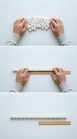 Business concept showing hands organizing scattered white blocks into orderly line using wooden ruler for planning and structure development.