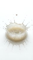 Milk splash crown with droplets on white background isolated for dairy product advertising and beverage marketing campaigns.