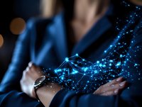 Businesswoman in dark suit interacting with glowing blue network visualization floating above hands, representing digital transformation and future technology.