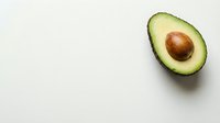 Fresh avocado half with pit on white background, ideal for food, nutrition, healthy eating, recipe, and culinary design projects.