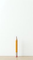 Sharpened yellow pencil with pink eraser standing upright on wooden surface against neutral background, isolated for design use on merchandise and educational materials.
