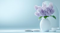 Delicate lilac flowers in white ceramic vase alongside open book and coffee cup on light blue background, creating serene spring morning atmosphere for lifestyle blogs.
