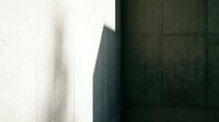 Modern minimalist architectural detail with concrete wall textures and dramatic shadow play creating geometric contrast between light and dark surfaces.