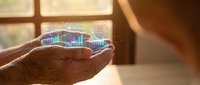 Mature male hand holding glowing holographic smart city model with digital buildings and network connections, representing urban technology innovation and future infrastructure development.
