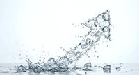 Dynamic water splash forming upward arrow shape with droplets and bubbles against clean white background for business growth concepts.
