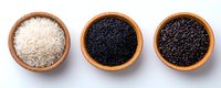 Raw white, black and brown rice varieties in wooden bowls arranged in row on white background, top view of healthy grain assortment isolated.