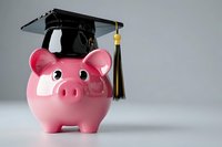 Pink piggy bank wearing a black graduation cap on a light gray background, symbolizing education savings, student loans, and financial planning.