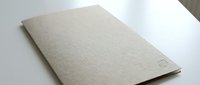 Blank beige cardboard notebook or sketchbook on white surface, ready for design mockups, branding presentations, or stationery projects.