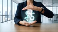 Professional businesswoman protecting glowing DNA helix hologram with hands in modern office, representing genetic research and biotechnology innovation.