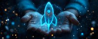 Glowing blue holographic rocket floating above cupped hands against dark background with bokeh light effects and magical particles, symbolizing innovation and startup.