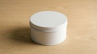 White round cosmetic jar with lid on wooden surface for skincare product packaging and beauty brand marketing materials.