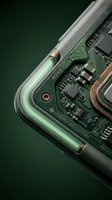 Smartphone internal components and circuit board exposed on green background, showcasing processor chip, electronic circuits, and metal components for technology and electronics industry use.