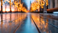 Wooden deck at sunset with bokeh lights from illuminated trees creating warm golden ambiance.
