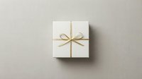 Elegant white gift box with golden ribbon and bow on neutral background, top view, minimalist style for holiday and luxury branding.
