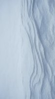 Close-up of soft, flowing white fabric with delicate folds and gentle shadows creating depth and texture. Suitable for backgrounds, textile design, and minimalist projects.