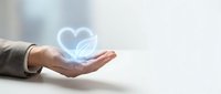 Caucasian hand holding glowing neon heart symbol on blurred background. Concept for healthcare, charity, love, wellness, and medical support services.