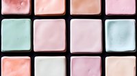 Soft pastel colored squares arranged in grid pattern with subtle watercolor texture and gentle gradient transitions creating minimalist geometric composition.