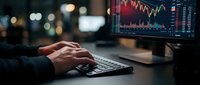 Professional trader analyzing financial market data on computer screen with colorful charts and graphs in modern office environment for investment decisions.
