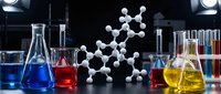 Laboratory glassware with colorful chemical solutions and molecular structure model for scientific research and education in chemistry and biochemistry.