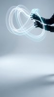 Hands manipulating glowing energy streams with flowing light trails in futuristic digital environment for technology and innovation concepts.