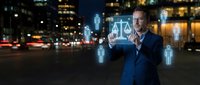 Professional businessman interacting with holographic justice scales interface in urban night setting with city lights background for legal technology concepts.