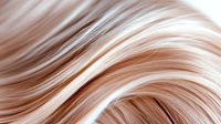 Smooth flowing waves of light rose gold and white hair strands create an elegant abstract pattern with soft curves and glossy highlights against dark background.