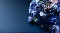 Luxury crystal perfume bottle with purple roses and pearls on dark blue background for elegant beauty and fragrance advertising campaigns.