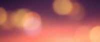 Soft bokeh lights blend across warm sunset gradient background, creating dreamy atmosphere for design projects and creative overlays.