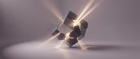 Stacked metallic cubes with glowing light rays emanating from center, creating dynamic energy effect on neutral background for design and technology concepts.