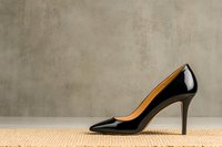 Classic black patent leather high heel pump on neutral textured background with copy space, elegant women's footwear for formal and business attire.