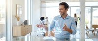 Professional businessman presenting data analytics with holographic charts in modern office workspace for corporate presentations and business meetings.