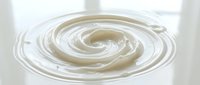 Creamy swirl of milk or yogurt in circular motion, suitable for dairy product packaging, food advertising, and culinary content.