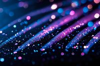 Vibrant blue and pink bokeh lights create magical sparkles and glowing dots on dark background, abstract macro photography with shallow depth of field.