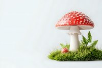 Red and white spotted amanita muscaria mushroom growing on moss patch with green fern leaves against light background, magical forest composition.