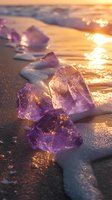 Purple amethyst crystals on sandy beach at sunset, with golden sunlight creating magical sparkles and reflections on wet sand and mineral surfaces.