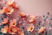 Delicate coral cosmos flowers with small pink blossoms and teal foliage against soft rose background create dreamy floral composition for romantic design projects.