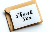 Elegant thank you note on white card with black golden envelope against white background, suitable for gratitude and appreciation messages.