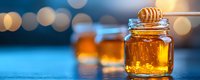Sweet honey dripping from wooden dipper into glass jar, golden liquid catching light with soft bokeh background and multiple jars creating depth.