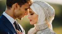 Young Muslim couple in intimate moment during golden hour wedding ceremony with bride wearing ornate hijab and groom in navy suit sharing tender embrace outdoors.