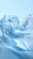 Flowing light blue silk fabric creating smooth waves and gentle folds against soft blue background, elegant minimal design for luxury fashion and beauty concepts.