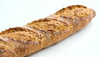 Crusty whole grain baguette with scored top and golden-brown crust, isolated on white background for bakery, food, and culinary design use.