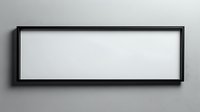 Horizontal black frame with empty white space mounted on gray wall, casting subtle shadow. Modern minimalist design element for mockup and presentation.