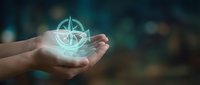 Hands holding glowing compass symbol with magical light effects for navigation and direction concepts in business and personal growth applications.