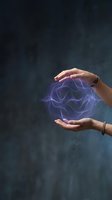 Two hands holding glowing purple abstract energy sphere with wavy lines against dark textured background, representing innovation, technology, and creative power for business concepts.
