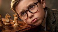 Young Caucasian boy with glasses contemplating chess strategy on wooden board with dramatic lighting. Strategic thinking and intellectual development concept.
