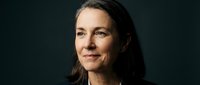 Professional mature woman with confident expression against dark background for corporate business portrait and executive headshot photography.