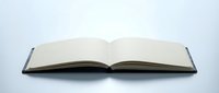 Open blank notebook with empty pages on white background isolated for education, writing, journaling and creative projects.