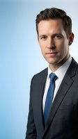 Professional Caucasian businessman in dark suit and blue tie portrait against gradient background for corporate marketing materials and business presentations.
